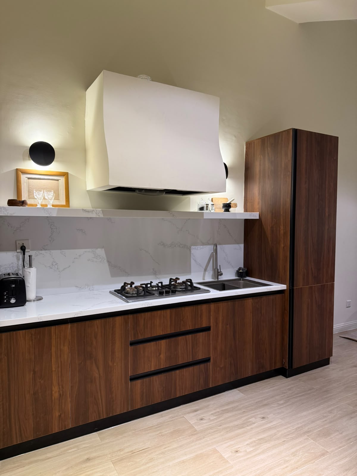 Fitted walnut kitchen with marble splashback in a completed apartment at MYG Nathiagali