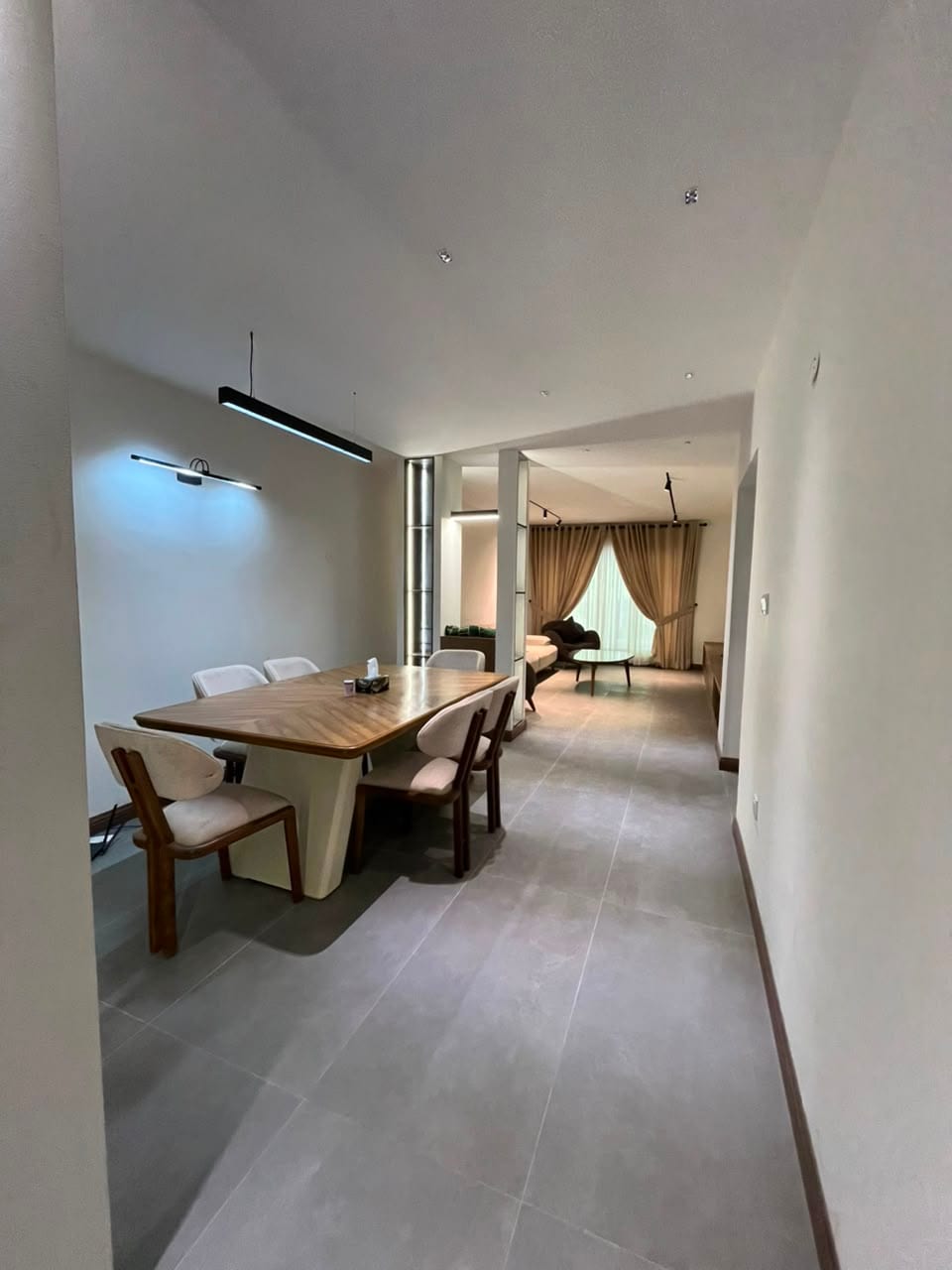 Dining room opening onto the lounge in a finished MYG Nathiagali apartment near Abbottabad, Galiyat
